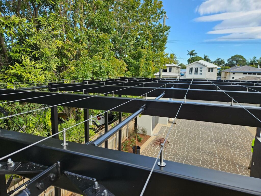 Construction beams featuring stainless steel cabling